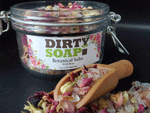 Jar of Dirty Soap Wild Rose Botanical Salt bath salts with wild rose petals and a wooden scoop.