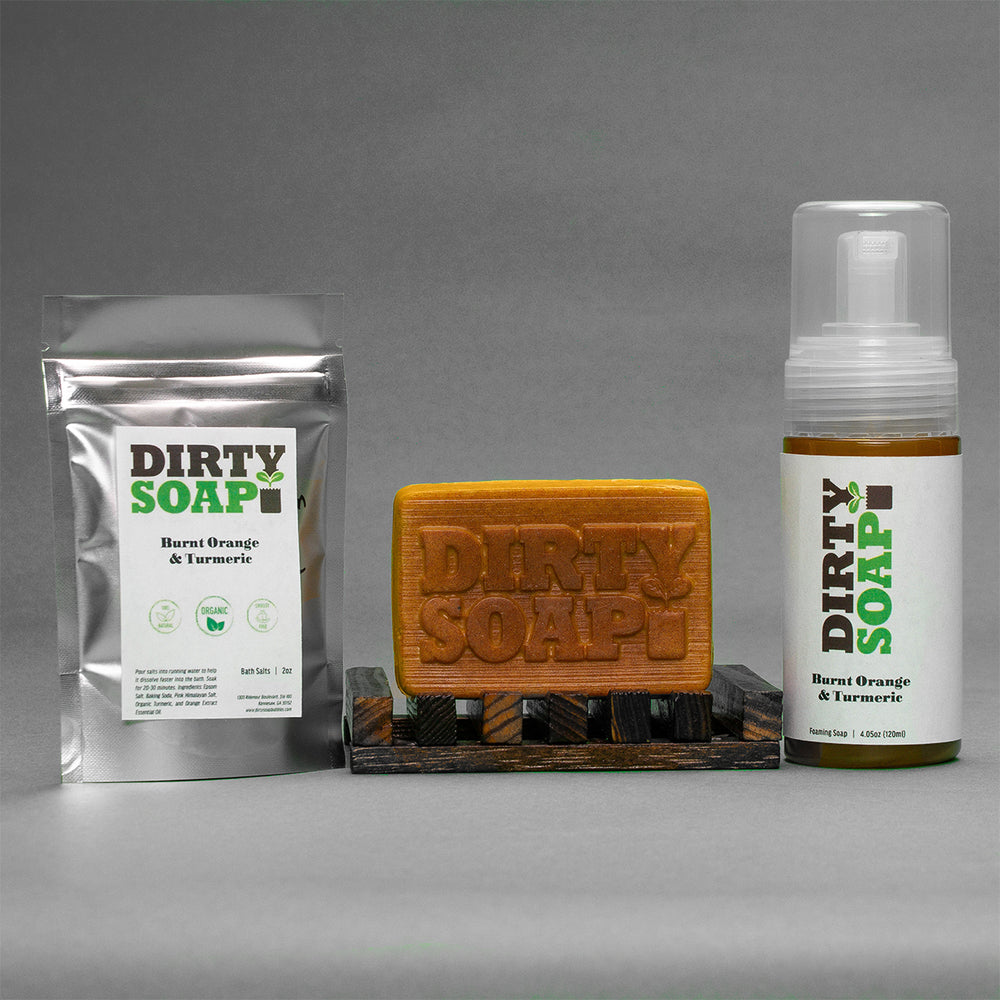 Assorted Dirty Soap products including bar soap, foam soap, and soap in a packet, with a focus on the Burnt Orange & Turmeric Set 20% Off from Dirty Soap.