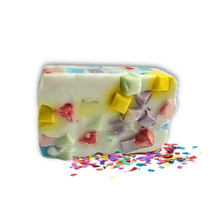 The Dirty Soap Confetti Soap Bar is a rectangular white bar with colorful chunks and confetti pieces, infused with refreshing Bergamot Essential Oil, shown on a white background.