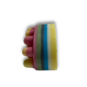 The Dirty Soap Blossom Massage Bar, infused with essential oils and featuring colorful stripes and rounded protrusions, sits on a white background—ideal for relaxation.