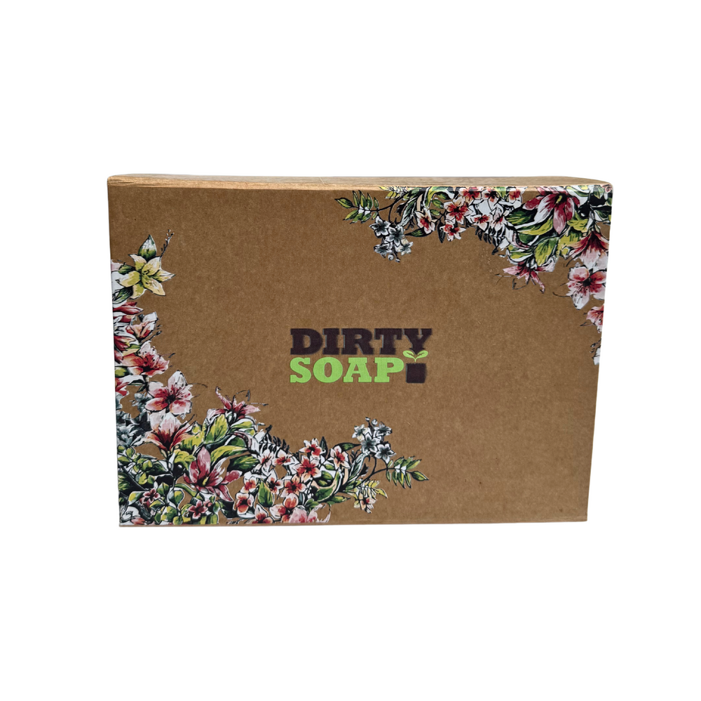 The Dirty Soap Gift Box Set by Dirty Soap features a brown cardboard box with floral patterns, perfect for body care essentials, shown on a white background.