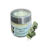 A 3.0 oz (89 ml) jar of Dirty Soap Bubbles Eucalyptus and Spearmint Whipped Body Butter is placed next to fresh eucalyptus leaves.