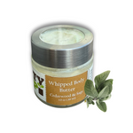 A 3.0 oz (89 ml) jar of Dirty Soap Bubbles Cedarwood And Sage Whipped Body Butter sits on a white background with a sage sprig, emphasizing this organic body butter's fresh, soothing appeal.