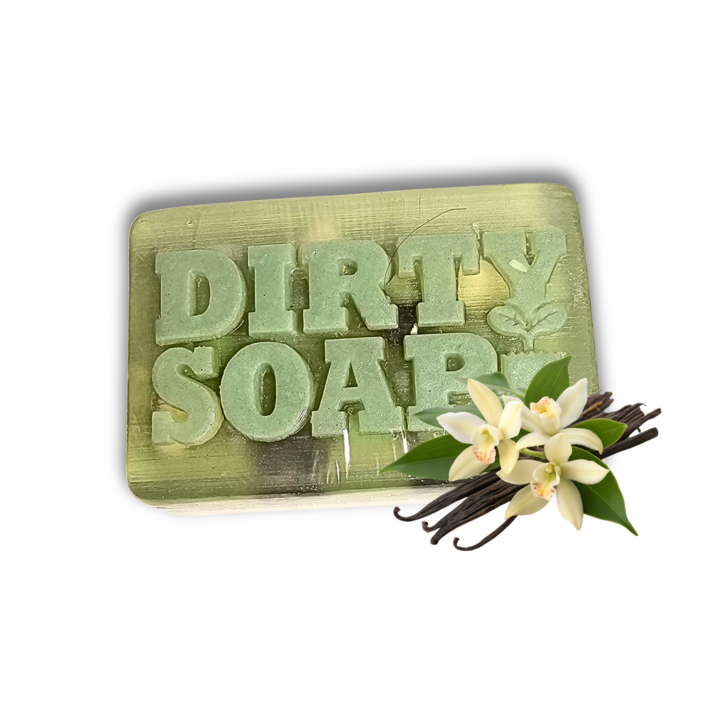 A green Self-Care Bar Soap by Dirty Soap Bubbles, engraved with "DIRTY SOAP" and scented with a calming vanilla lilac fragrance, is shown with vanilla flowers and beans in the lower right corner.