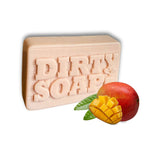 Dirty Soap's Mango and Bergamot Bar Soap is showcased in front of a whole and sliced mango, highlighting its handcrafted blend for natural aromatherapy.