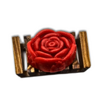 The Dirty Soap Shoppe Red Rose Flower Soap, shaped like a bloom and infused with calming rose essential oil, sits elegantly on a small rectangular gold and brown wooden platform.