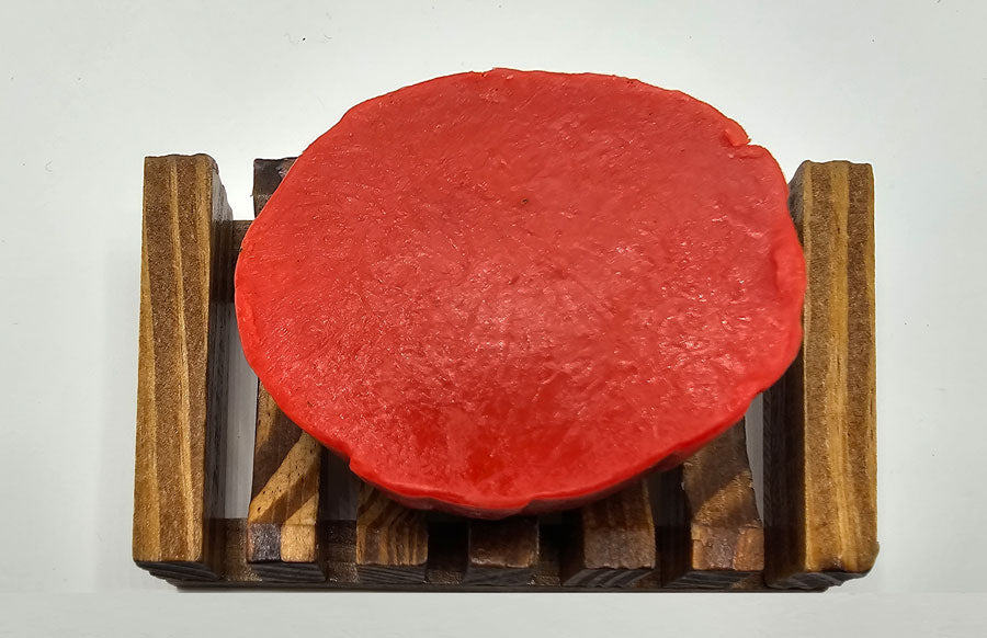 A round Red Rose Flower Soap on a wooden rack, displayed against a white background, with delicate hints of Lemon Essential Oil adding a fresh and citrusy aroma.