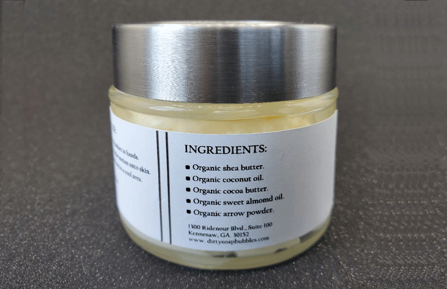 A jar of Original Whipped Body Butter with Shea Butter and a list of natural ingredients on the label by Dirty Soap Bubbles.