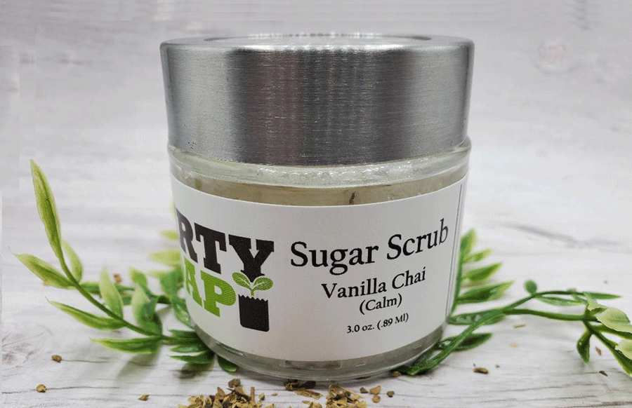 Jar of organic Vanilla Chai Sugar Scrub (Calm) with leaves around it by Dirty Soap Bubbles.