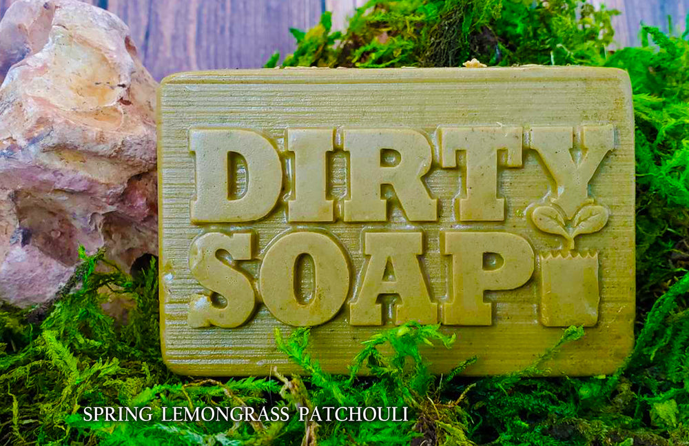 Handmade "Spring Lemongrass & Patchouli with Macha Tea" bar soap with coconut oil, displayed on a natural mossy backdrop by Dirty Soap Bubbles.